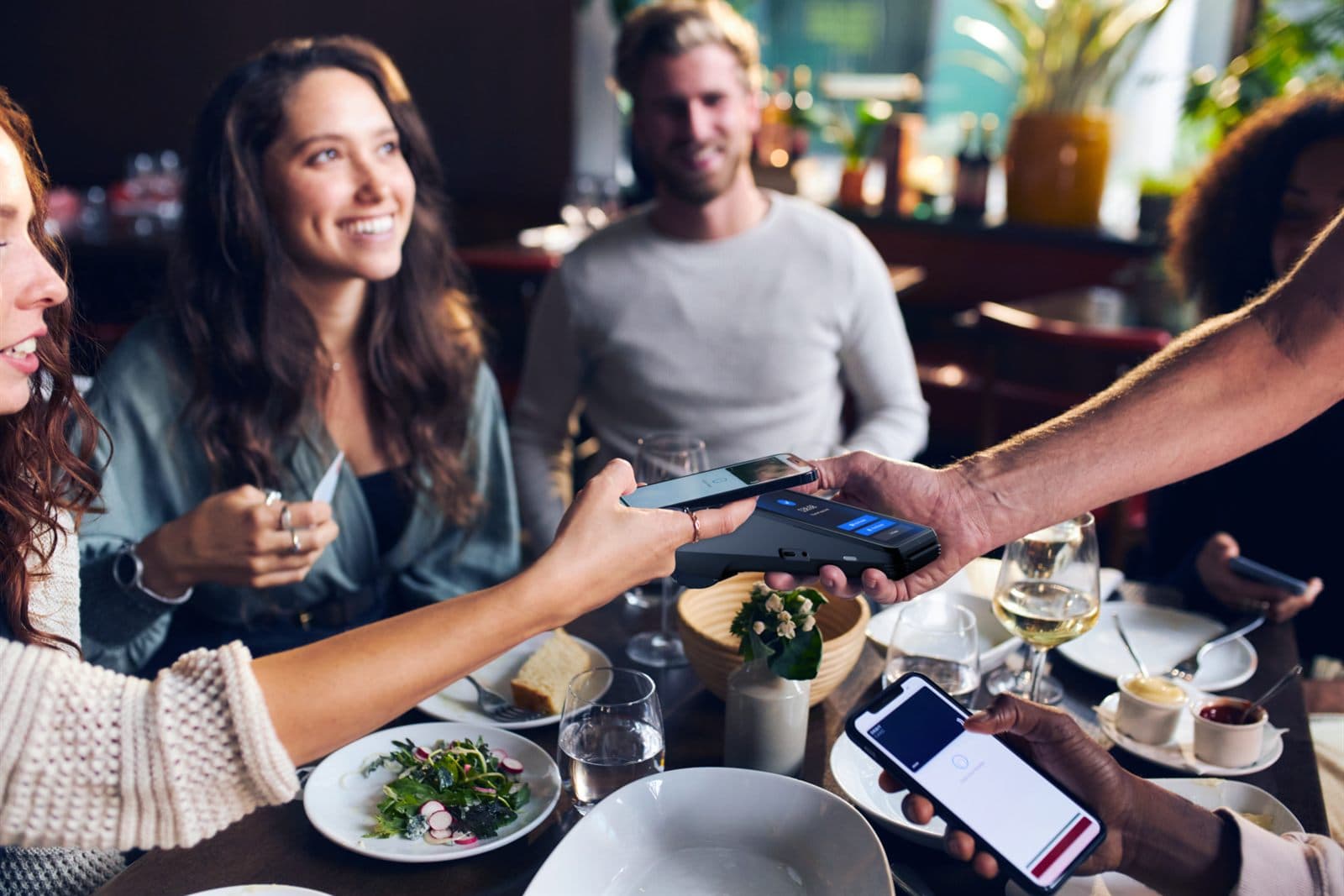 Server delivering smooth, modern table service in a busy restaurant