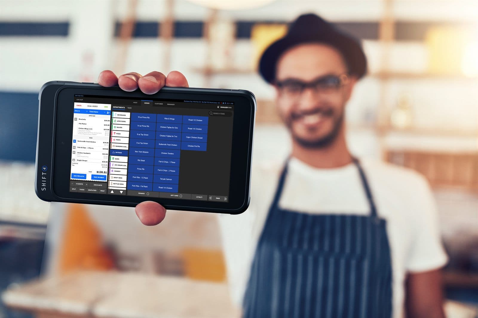 Restaurant owner holding a Shift4 handheld showing live orders